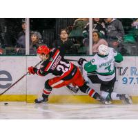 Michael Rasmussen of the Grand Rapids Griffins squeezes past the Texas Stars