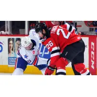 Eric Tangradi of the Binghamton Devils (right) faces off against the Rochester Americans