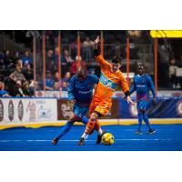Leo Gibson of the Kansas City Comets (left) challenges a member of the Florida Tropics