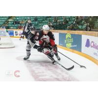 Prince George Cougars centre Ethan Browne (right) with the puck against the Vancouver Giants