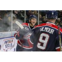 Saginaw Spirit exchange congratulations after a goal against the Owen Sound Attack