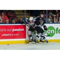 Vancouver Giants right wing Davis Koch pins a Kelowna Rocket against the boards