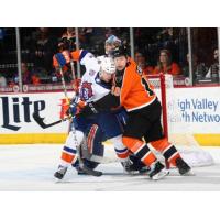 Lehigh Valley Phantoms left wing Greg Carey muscles in against the Bridgeport Sound Tigers