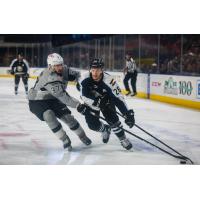Jake Walman of the San Antonio Rampage (left) defends Colorado Eagles forward Andrew Agozzino