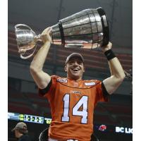 Travis Lulay hoists the Grey Cup with the B.C. Lions