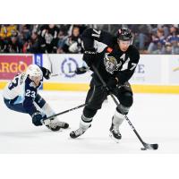 Jordan Nolan of the San Antonio Rampage skates past the Milwaukee Admirals' Adam Helewka