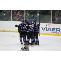 Tri-City Storm huddle in celebration after a goal