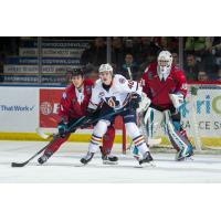 Kelowna Rockets in their Don Cherry jerseys try to keep the Kamloops Blazers at bay