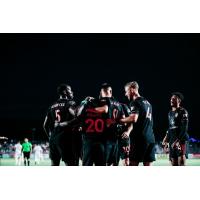 Phoenix Rising FC congratulate Solomon Asante after a goal against the Oakland Roots