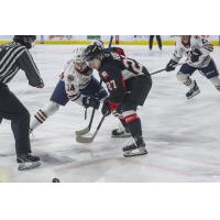 Prince George Cougars centre Riley Heidt (right) faces off with the Kamloops Blazers