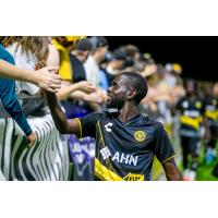 Kenardo Forbes of the Pittsburgh Riverhounds shakes hands with the fans